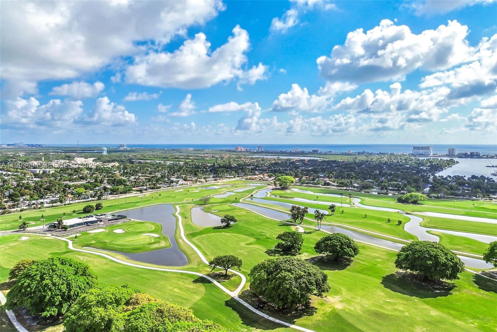 An aerial view shows a sprawling golf course with winding ponds and surrounding residential areas — 1700 Pierce St # 804, Hollywood FL 33020, HOLLYWOOD, FL
