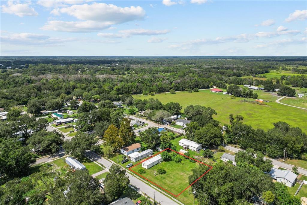 An aerial view shows a rectangular residential lot outlined in red with a mobile home — 636 3RD STREET, POLK CITY, FL