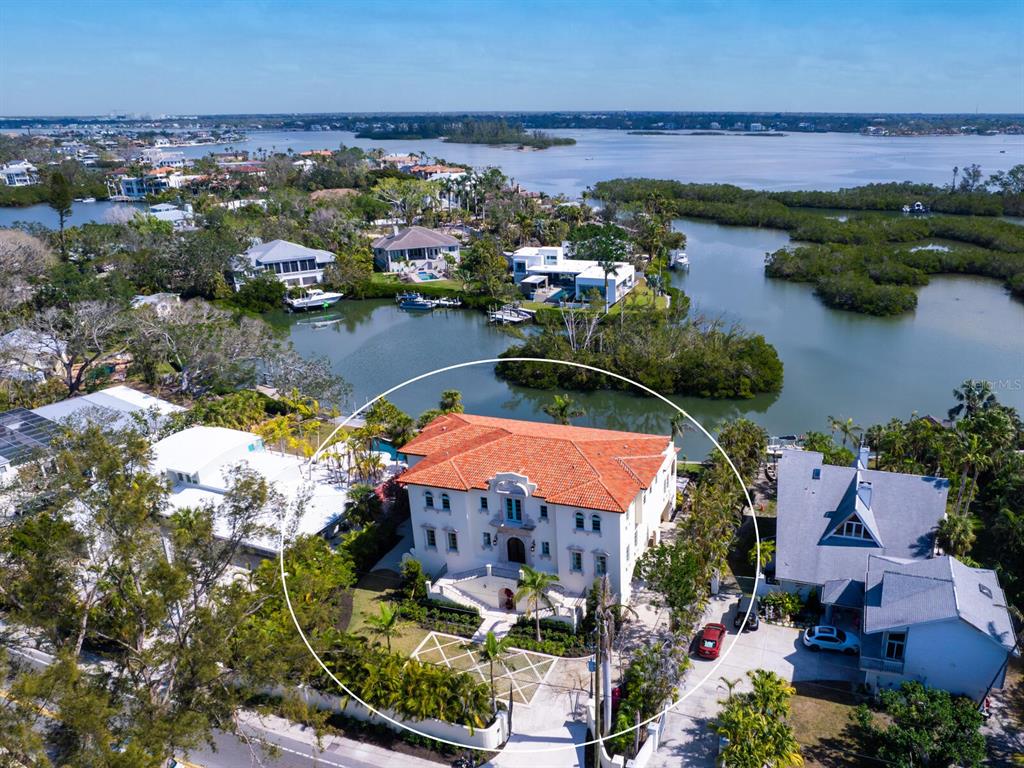 An aerial view shows a large, multi-story Mediterranean-style house with a red tile roof — 4205 HIGEL AVENUE, SARASOTA, FL