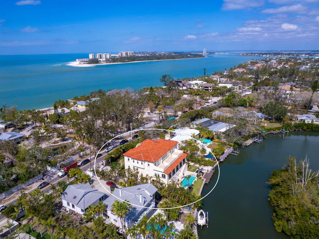 An aerial view shows a large multi-story house with a red tile roof and pool — 4205 HIGEL AVENUE, SARASOTA, FL