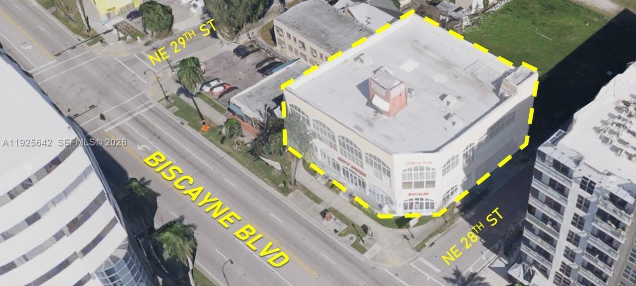 An aerial view shows a multi-story commercial building outlined in yellow at a street intersection — 2801 BISCAYNE BLVD, Miami FL 33137, MIAMI, FL