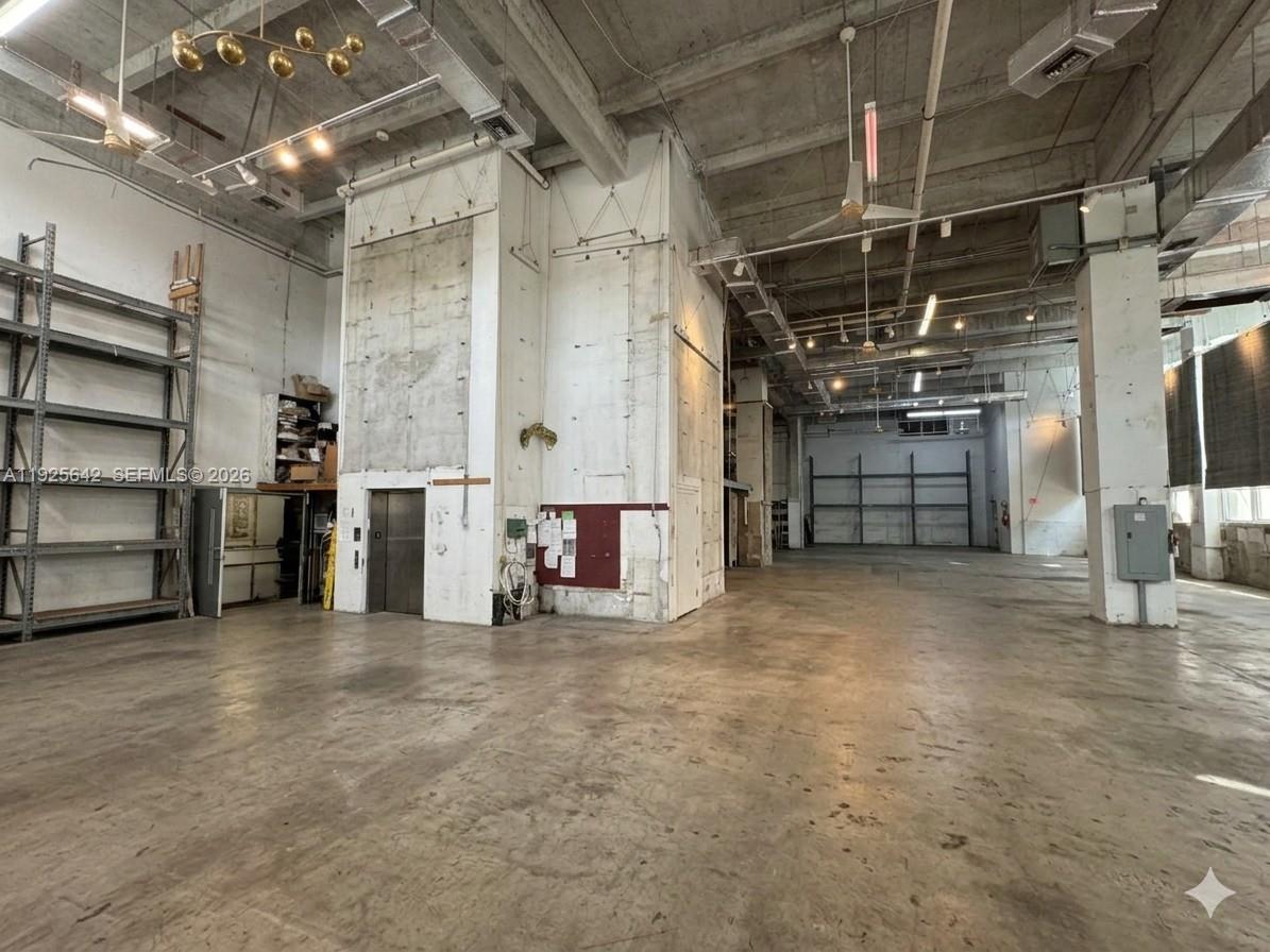 A large, open industrial warehouse space features concrete floors, exposed ceilings, and a freight elevator — 2801 BISCAYNE BLVD, Miami FL 33137, MIAMI, FL