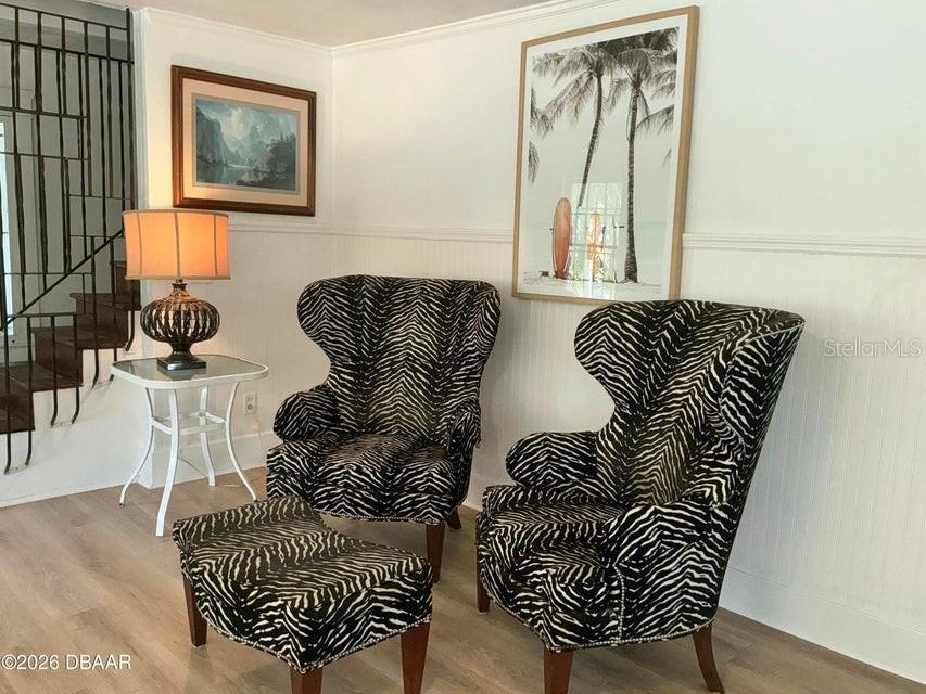 A living area features two zebra-print wingback chairs, a matching ottoman, and a side table — 711 S PALMETTO AVENUE, DAYTONA BEACH, FL