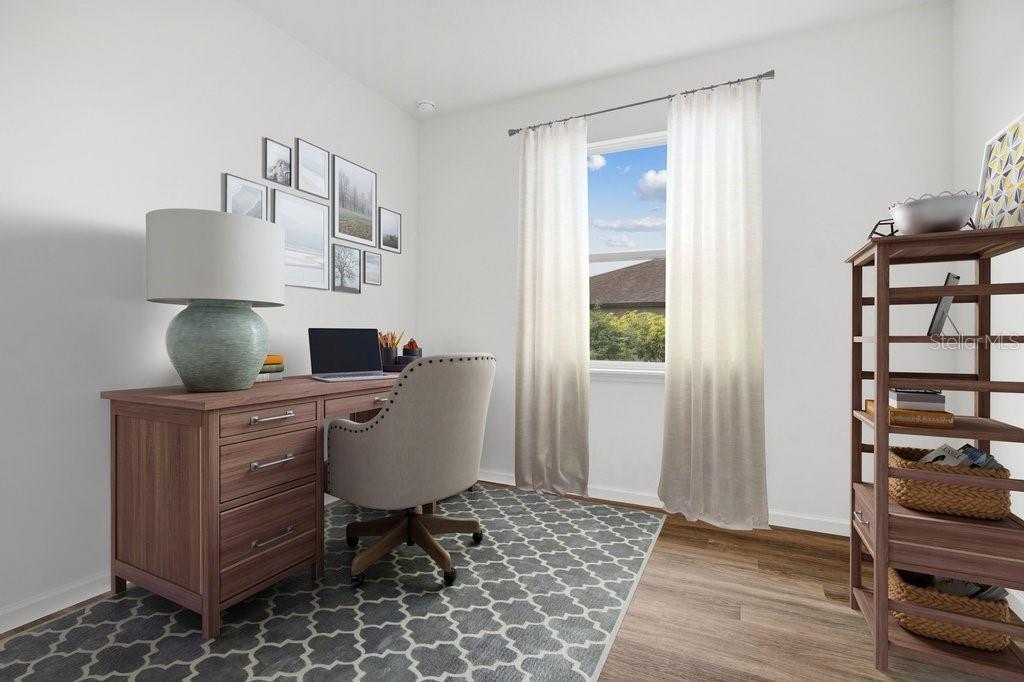 A home office features a wooden desk, a gray chair, a bookshelf, and a window — 7 BUFFALO BILL DRIVE, PALM COAST, FL