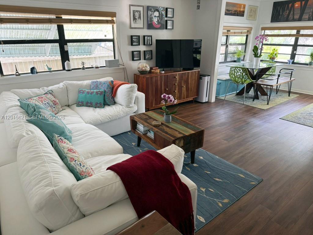 A living room features a white sectional sofa, a wooden coffee table, and a dining area — 324 SW 3rd Ave, Delray Beach FL 33444, DELRAY BEACH, FL