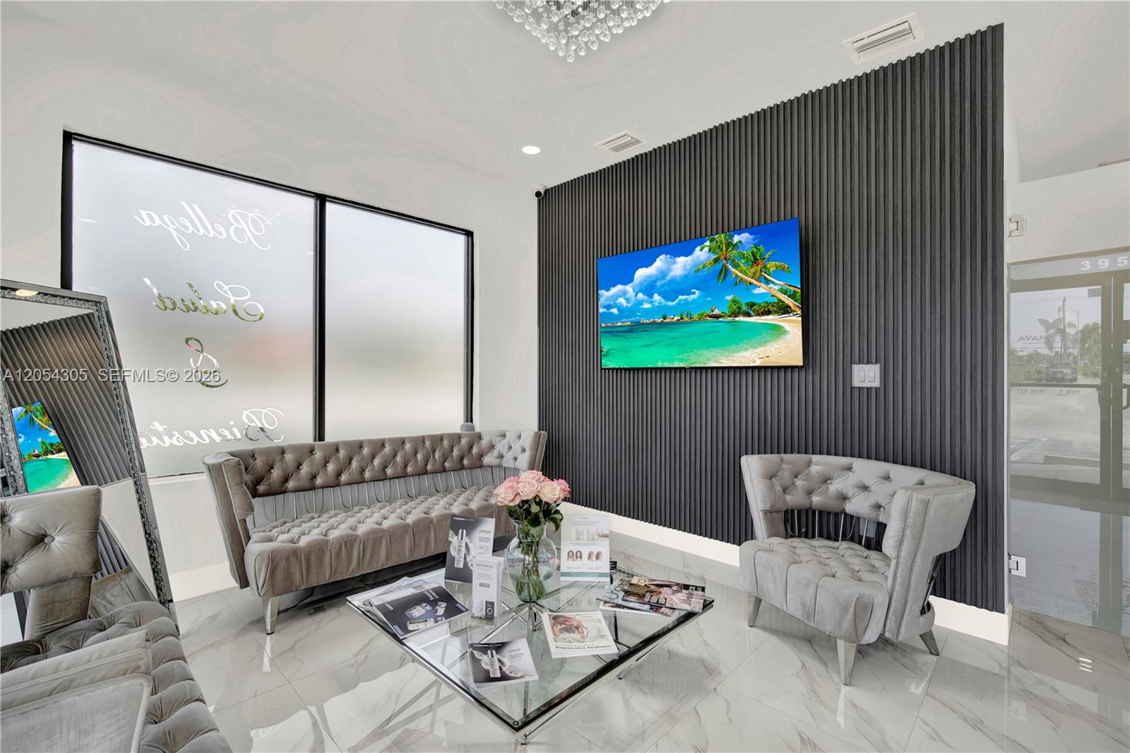 A waiting room features tufted gray furniture, a glass coffee table, and a slatted accent wall — 3855 SW 137th Ave, Miami FL 33175, MIAMI, FL