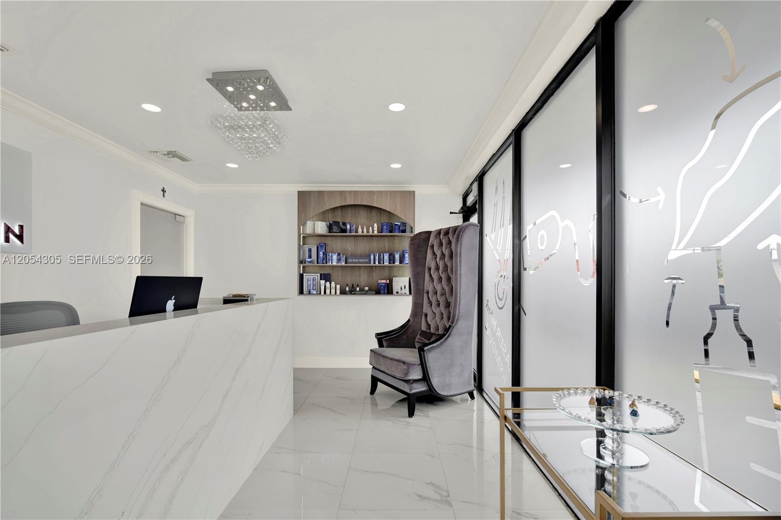 A modern reception area features a marble desk, a high-backed velvet chair, and glass partitions — 3855 SW 137th Ave, Miami FL 33175, MIAMI, FL