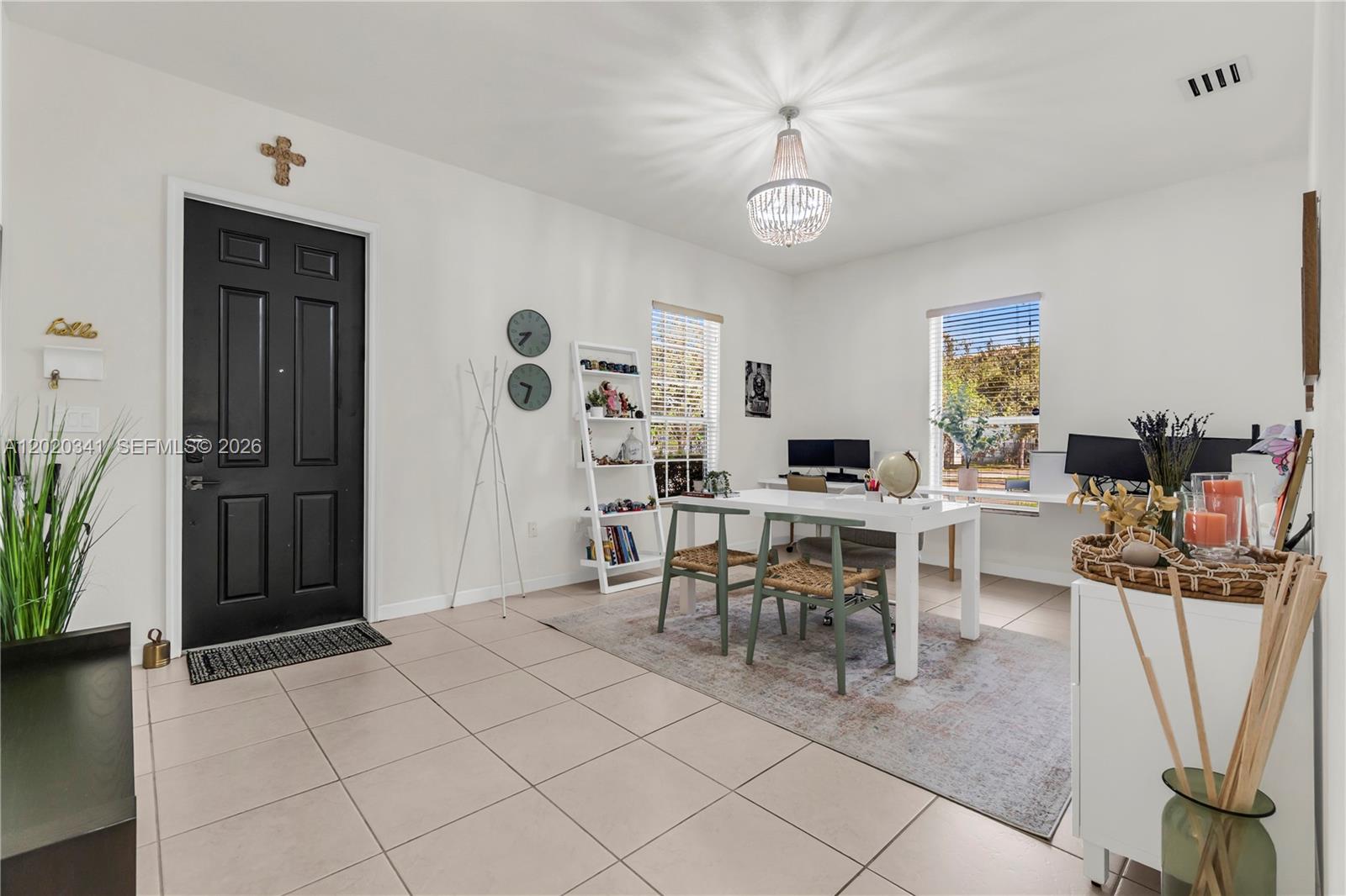 A bright home office features a white desk, two chairs, a chandelier, and tile flooring — 17064 SW 90th Way, Miami FL 33196, MIAMI, FL