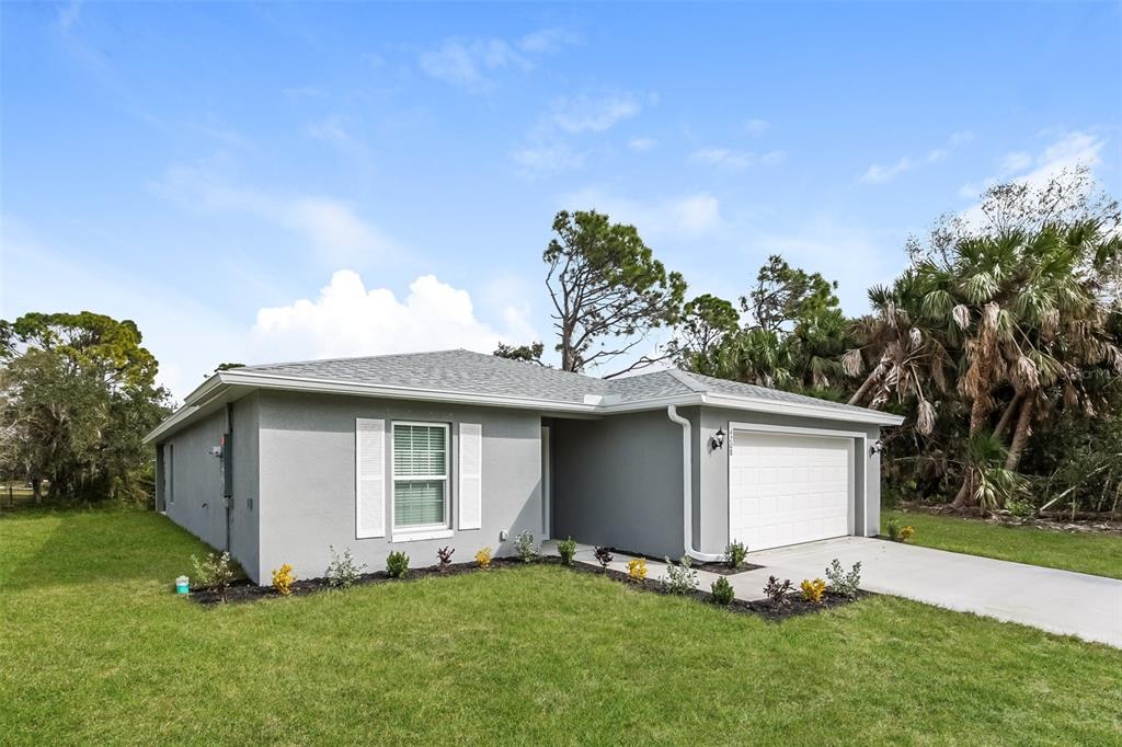 A single-story gray house with a white garage door and a front lawn — 4208 WALL LANE, NORTH PORT, FL