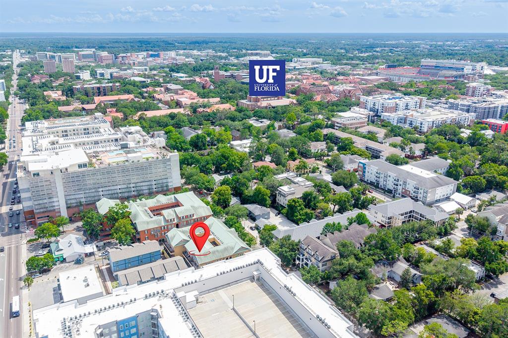 An aerial view shows a multi-story building complex with a red location pin — 325 NW 14TH STREET UNIT 205, GAINESVILLE, FL