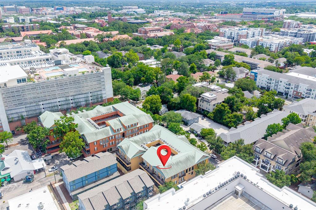 An aerial view shows a multi-story apartment complex with a red location pin — 325 NW 14TH STREET UNIT 205, GAINESVILLE, FL