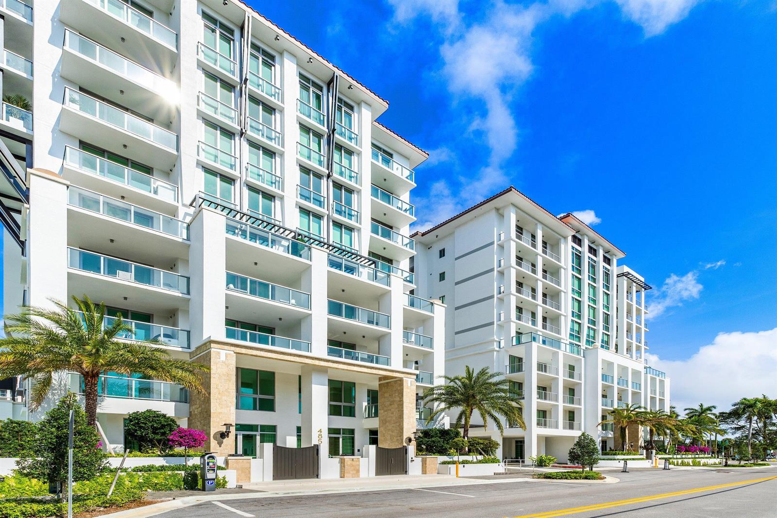 A multi-story white residential building with glass balconies and palm trees under a blue sky — 475 E Royal Palm Road # 206, Boca Raton FL 33432, BOCA RATON, FL