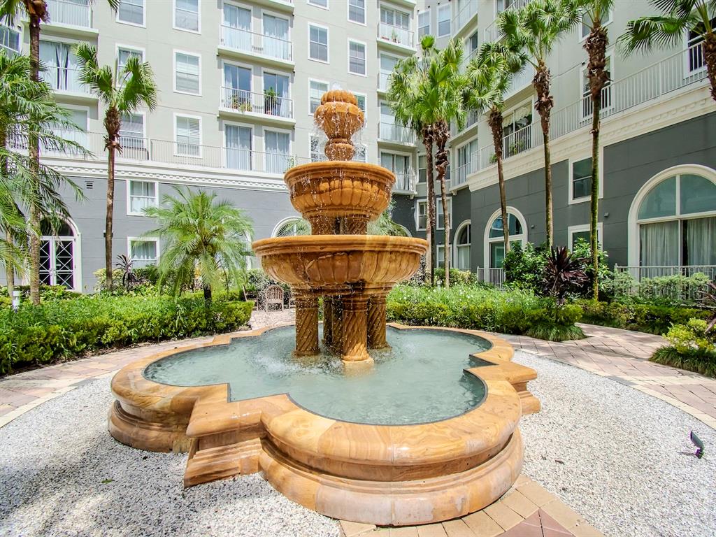 A tiered stone fountain sits in a courtyard surrounded by palm trees and apartment buildings — 700 S HARBOUR ISLAND BOULEVARD UNIT 245, TAMPA, FL