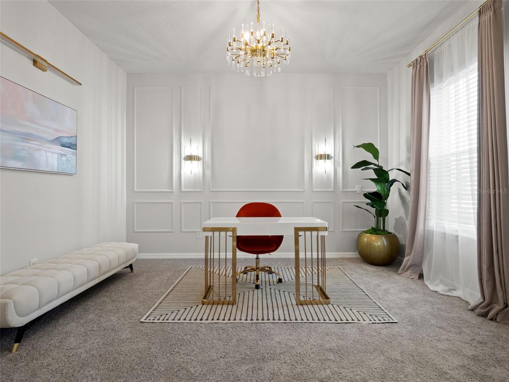 A home office features a white desk, red chair, wall molding, and a crystal chandelier — 3367 CANYON GRAND POINT, LONGWOOD, FL