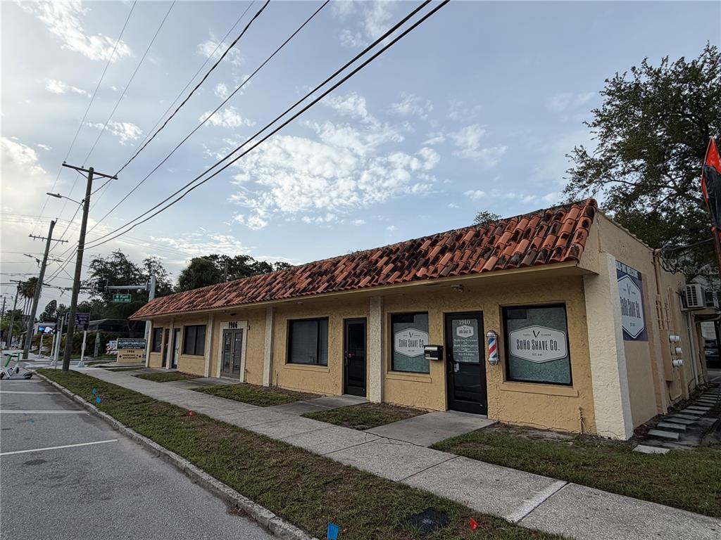 A low-rise commercial building with a terracotta tile roof and a barber shop storefront — 1906 W PLATT STREET, TAMPA, FL