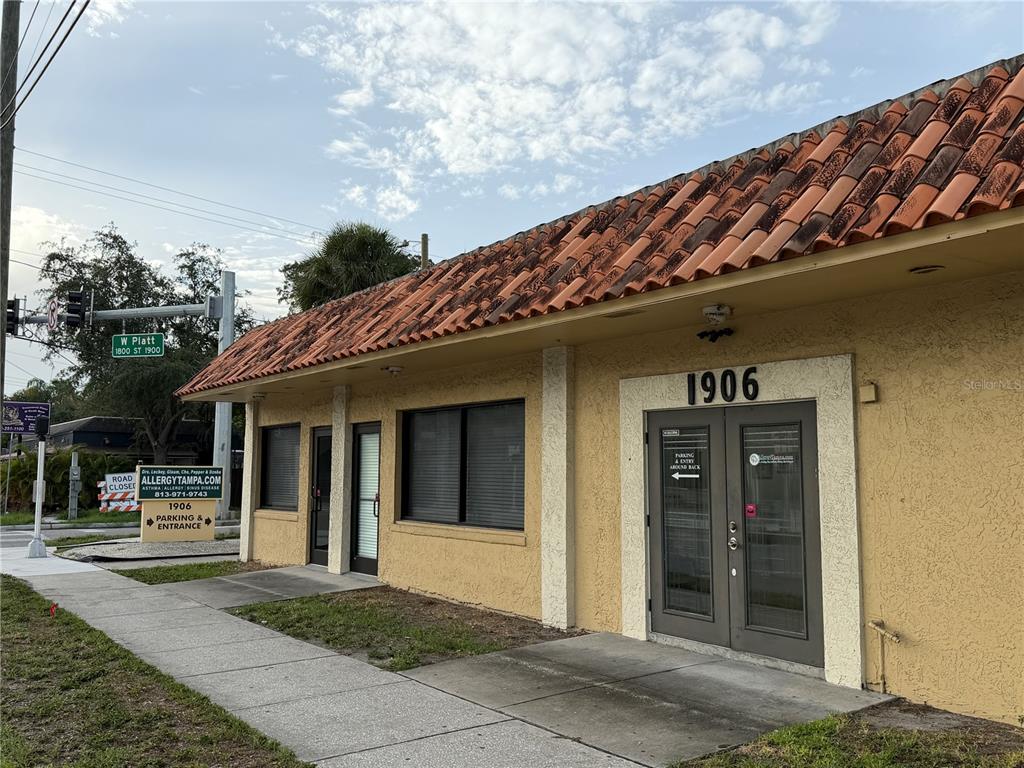 A single-story commercial building with a terracotta tile roof and a tan stucco exterior — 1906 W PLATT STREET, TAMPA, FL