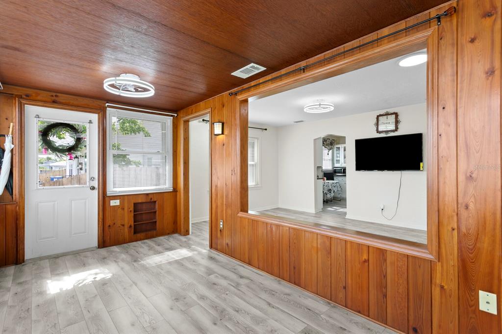 A large backyard features a grassy lawn, a patio with outdoor furniture, and a fence — 3152 13TH AVENUE N, ST PETERSBURG, FL