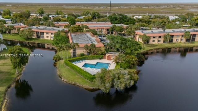 An aerial view shows apartment buildings surrounding a swimming pool located on a small peninsula — 182 Lakeview Dr # 204, Weston FL 33326, WESTON, FL