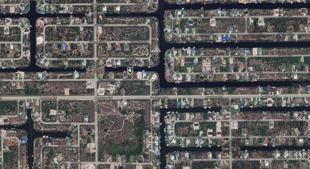 This is an aerial map view of a residential neighborhood with canals and vacant lots — 14432 FORT MYERS AVENUE, PORT CHARLOTTE, FL