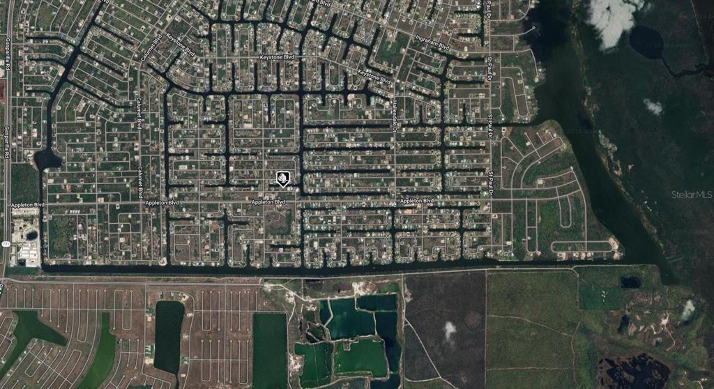This is an aerial map view of a residential neighborhood with canal-front homes — 14432 FORT MYERS AVENUE, PORT CHARLOTTE, FL