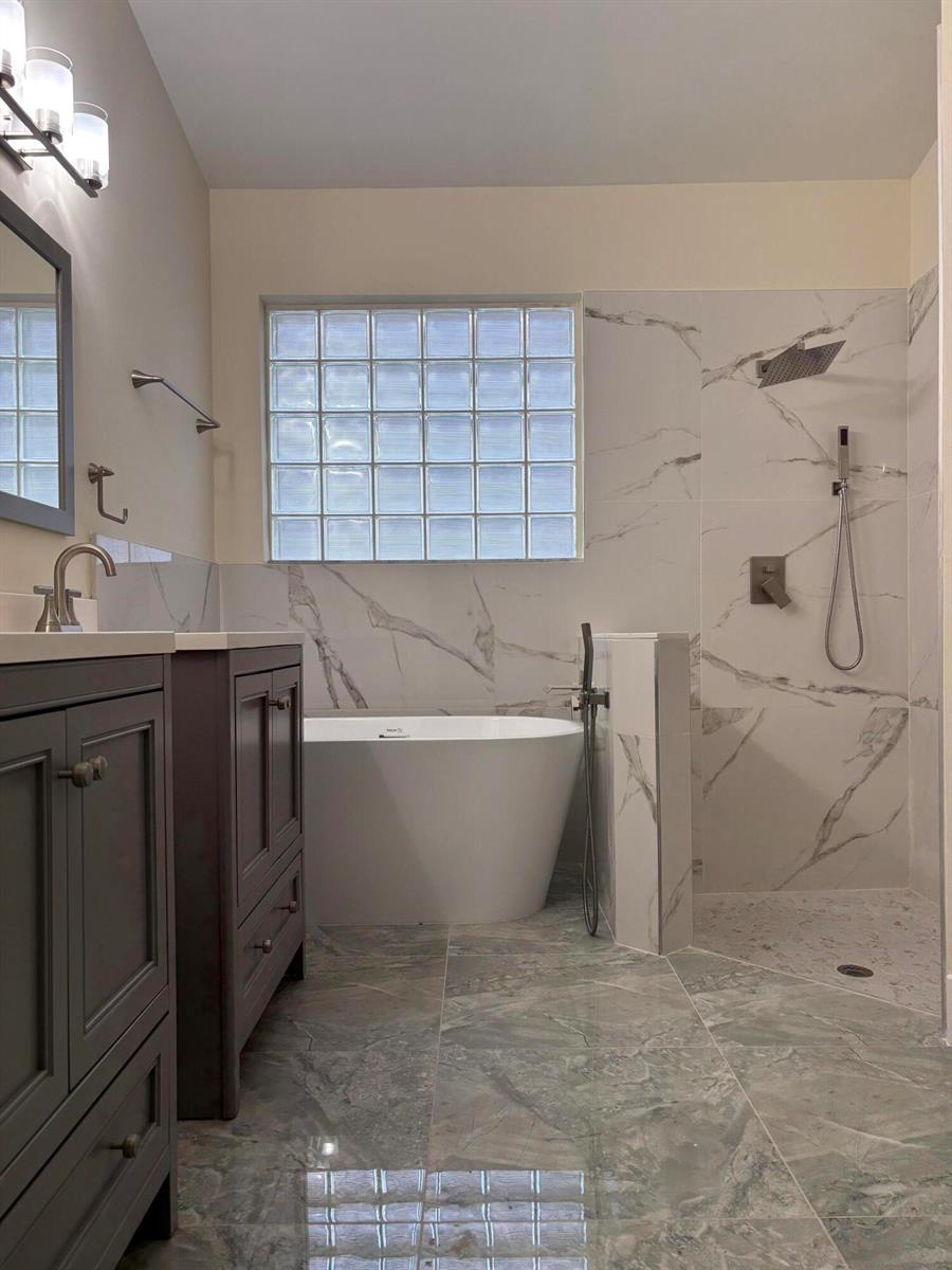 A bathroom features a freestanding tub, a walk-in shower, and a dark wood vanity — 9676 Cherry Blossom Court, Boynton Beach FL 33437, BOYNTON BEACH, FL