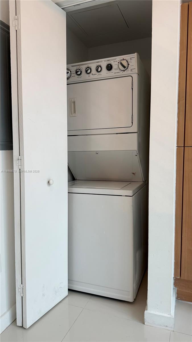 A white stacked washer and dryer unit is located inside a small closet — 350 S Miami Ave # 302, Miami FL 33130, MIAMI, FL