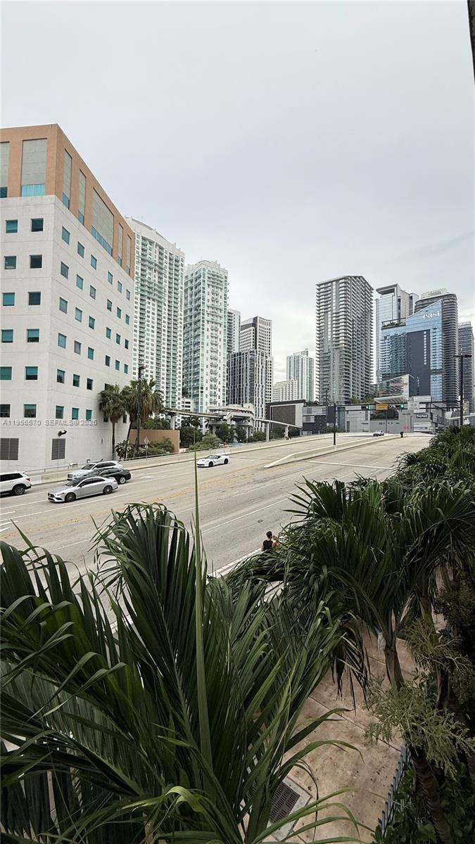 An elevated view of a multi-lane city street lined with tall skyscrapers and palm trees — 350 S Miami Ave # 302, Miami FL 33130, MIAMI, FL