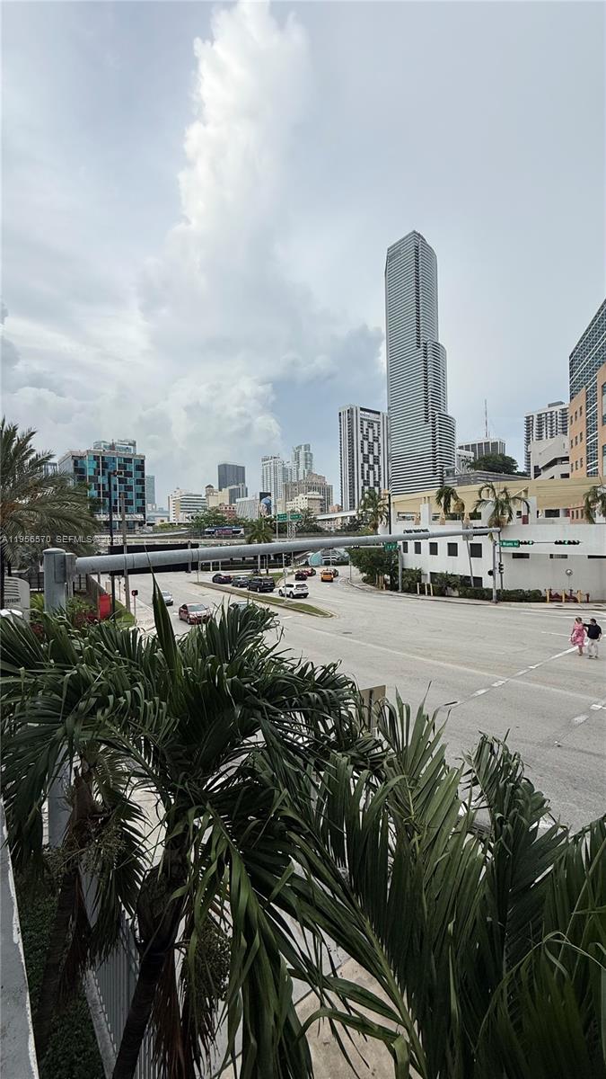 An elevated view of a city street intersection with palm trees and skyscrapers — 350 S Miami Ave # 302, Miami FL 33130, MIAMI, FL