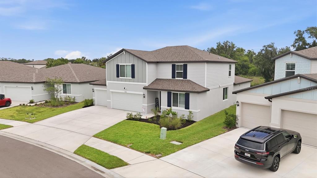 An exterior view of a two-story suburban house with a garage and a driveway — 14026 GINNIE SPRINGS WAY, PARRISH, FL