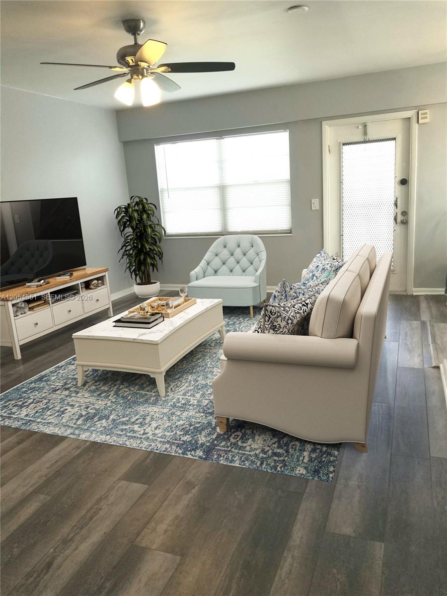 A living room features a light-colored sofa, a coffee table, and a blue accent chair — 285 Fanshaw G # G, Boca Raton FL 33434, BOCA RATON, FL