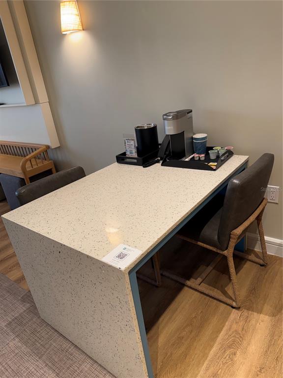 A hotel room desk area features a coffee station, two chairs, and a light-colored countertop — 3151 SUNSET WALK DRIVE UNIT 416, KISSIMMEE, FL