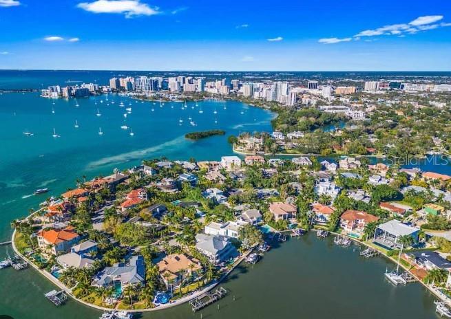 An aerial view shows waterfront luxury homes on a peninsula surrounded by a bay — 1387 HARBOR DRIVE, SARASOTA, FL