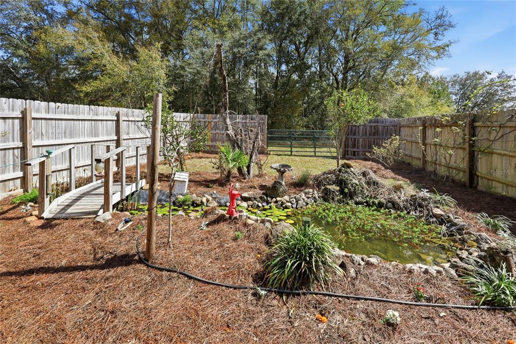 A single-story brick house with a covered front porch and a large grassy yard — 22317 NW 188TH STREET, HIGH SPRINGS, FL