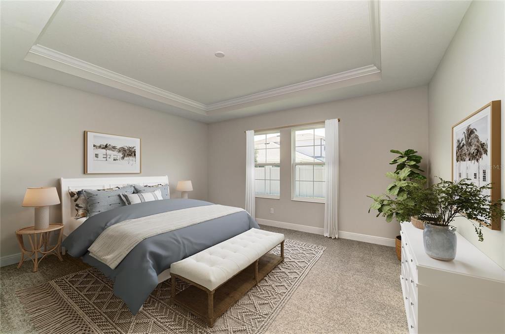 A bedroom features a tray ceiling, gray carpeting, a bed with a bench, and two windows — 33496 TWILIGHT SEA PLACE, DADE CITY, FL