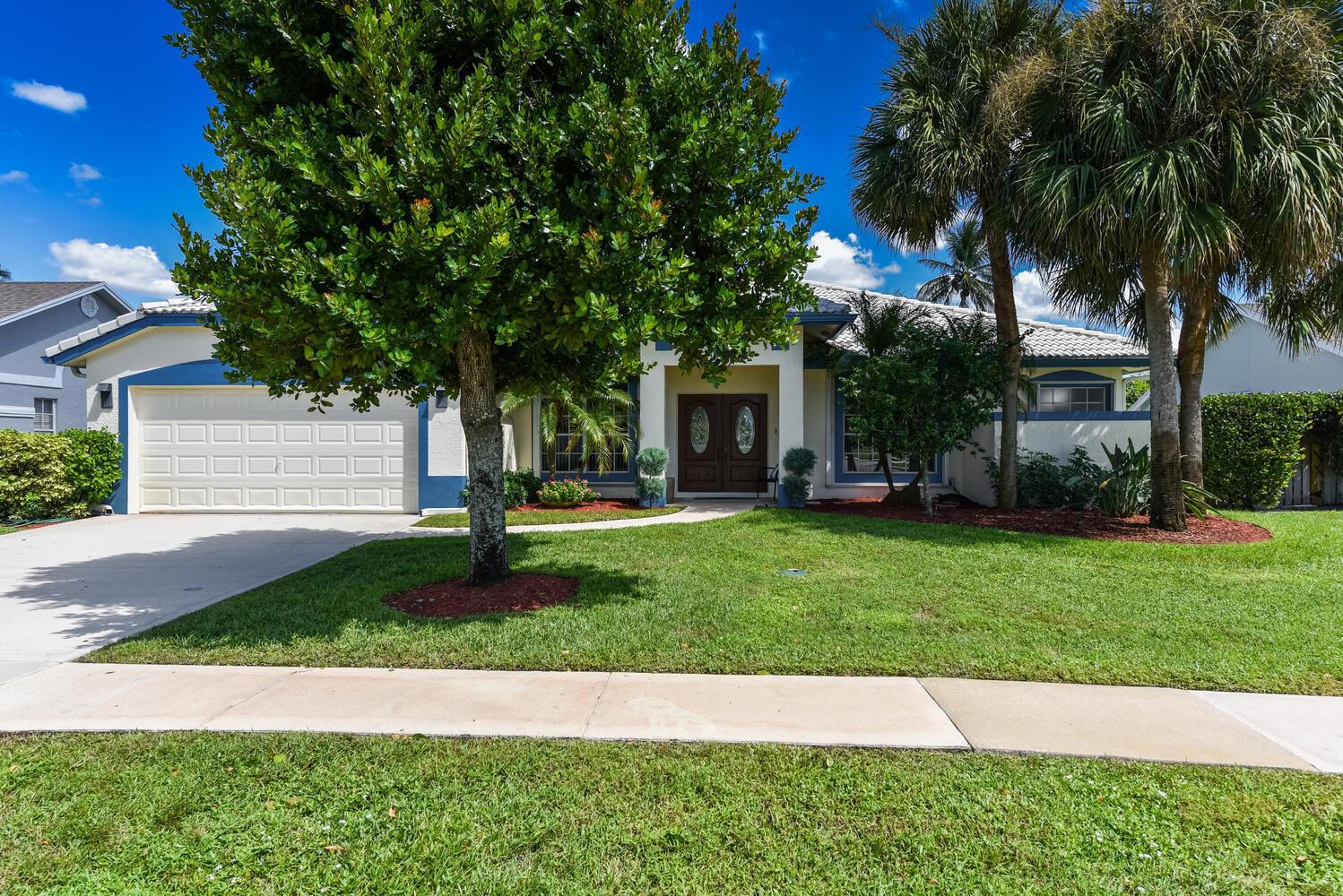 An aerial view shows a single-story house with a tiled roof, driveway, and front yard — 1935 Primrose Lane, Wellington FL 33414, WELLINGTON, FL