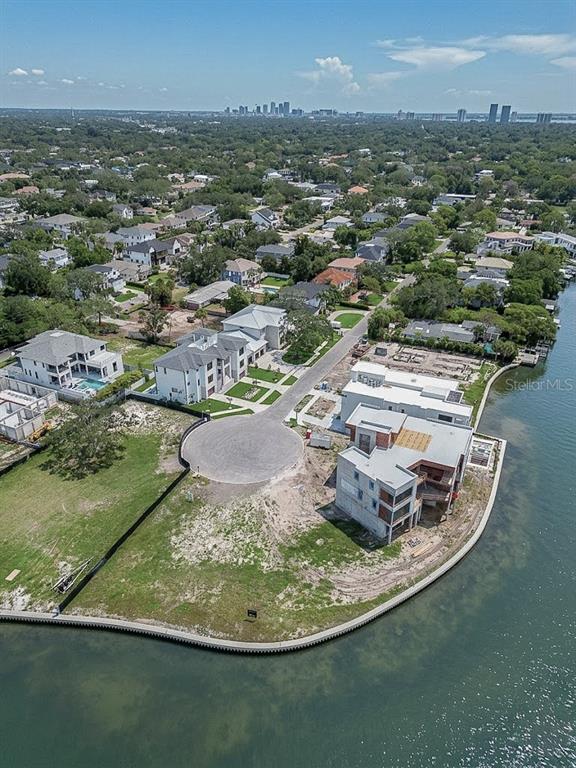 An aerial view shows waterfront residential lots with new construction homes and a cul-de-sac — 5028 W LEONA STREET, TAMPA, FL