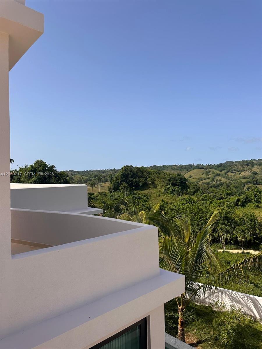 A white balcony overlooks a lush green landscape under a clear blue sky — 0 LA NOVILLA, AK 99999, AK