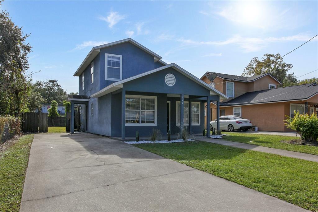 A two-story blue house with a front porch and a concrete driveway — 822 POLK STREET, ORLANDO, FL