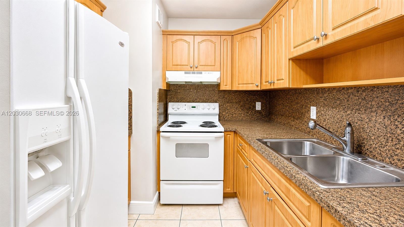 A kitchen features light wood cabinets, white appliances, and brown speckled laminate countertops — 9100 SW 137th Ter # 3, Miami FL 33176, MIAMI, FL
