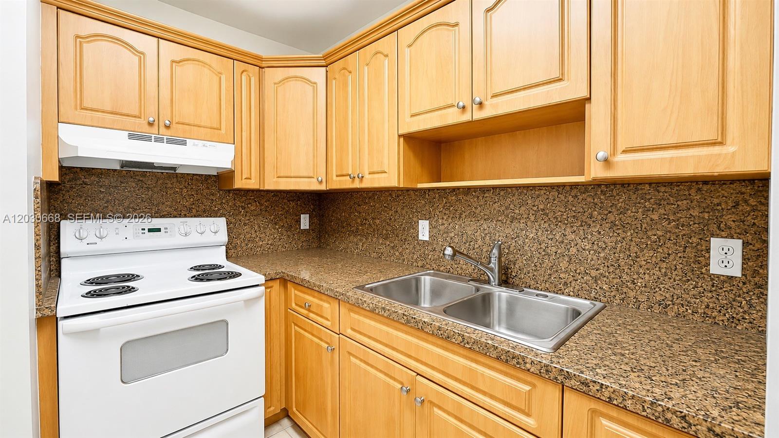 A kitchen features light wood cabinets, a white stove, and speckled brown countertops — 9100 SW 137th Ter # 3, Miami FL 33176, MIAMI, FL