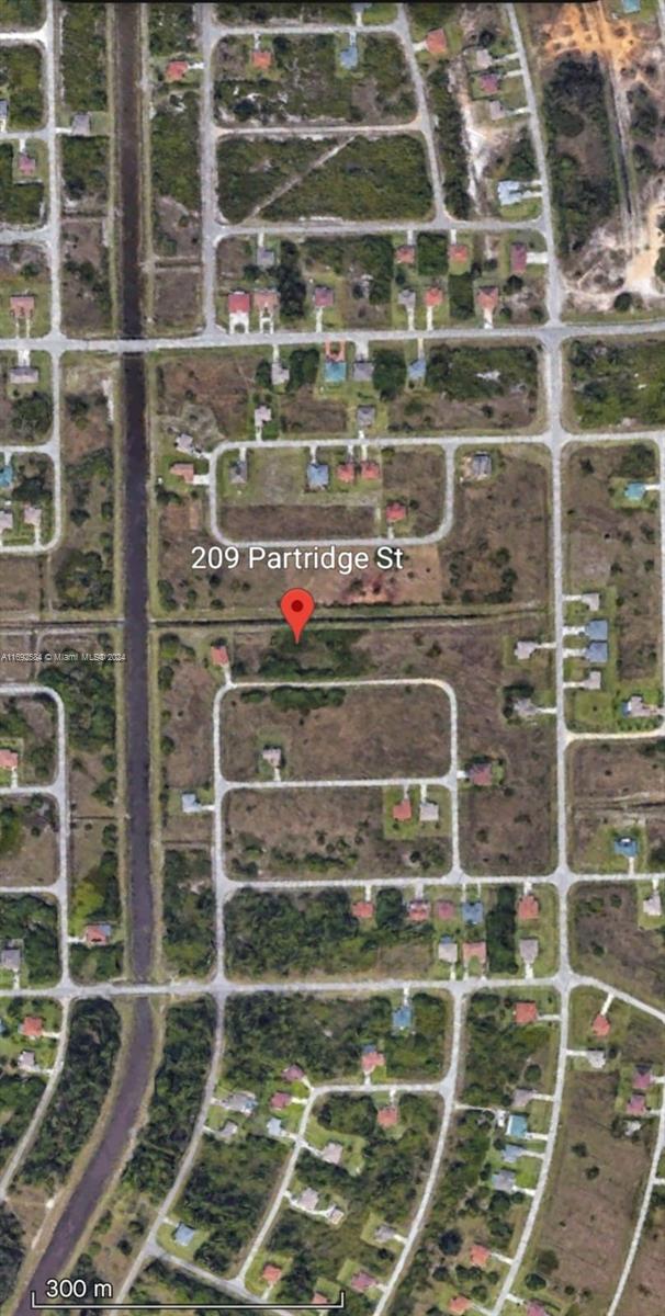 This is an aerial map view of a vacant residential lot in a suburban neighborhood — 209 Partridge St, Lehigh Acres FL 33974, LEHIGH ACRES, FL