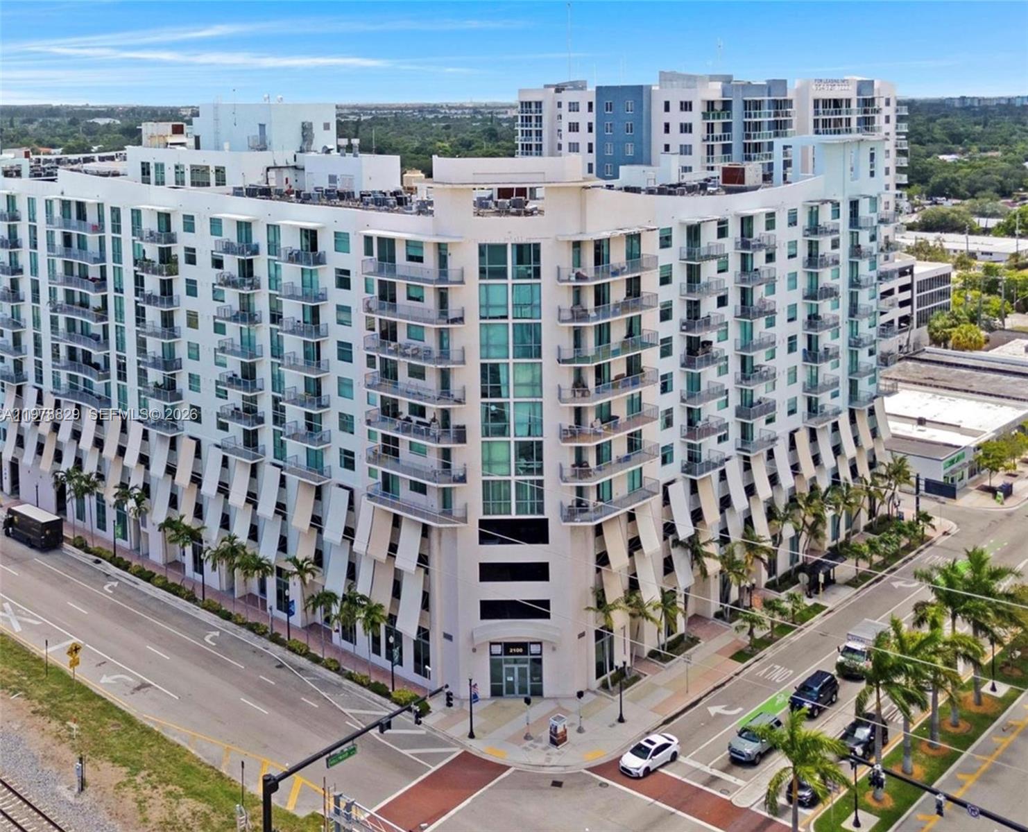 An aerial view of a multi-story white apartment building at a street intersection — 140 S Dixie Hwy # 719, Hollywood FL 33020, HOLLYWOOD, FL