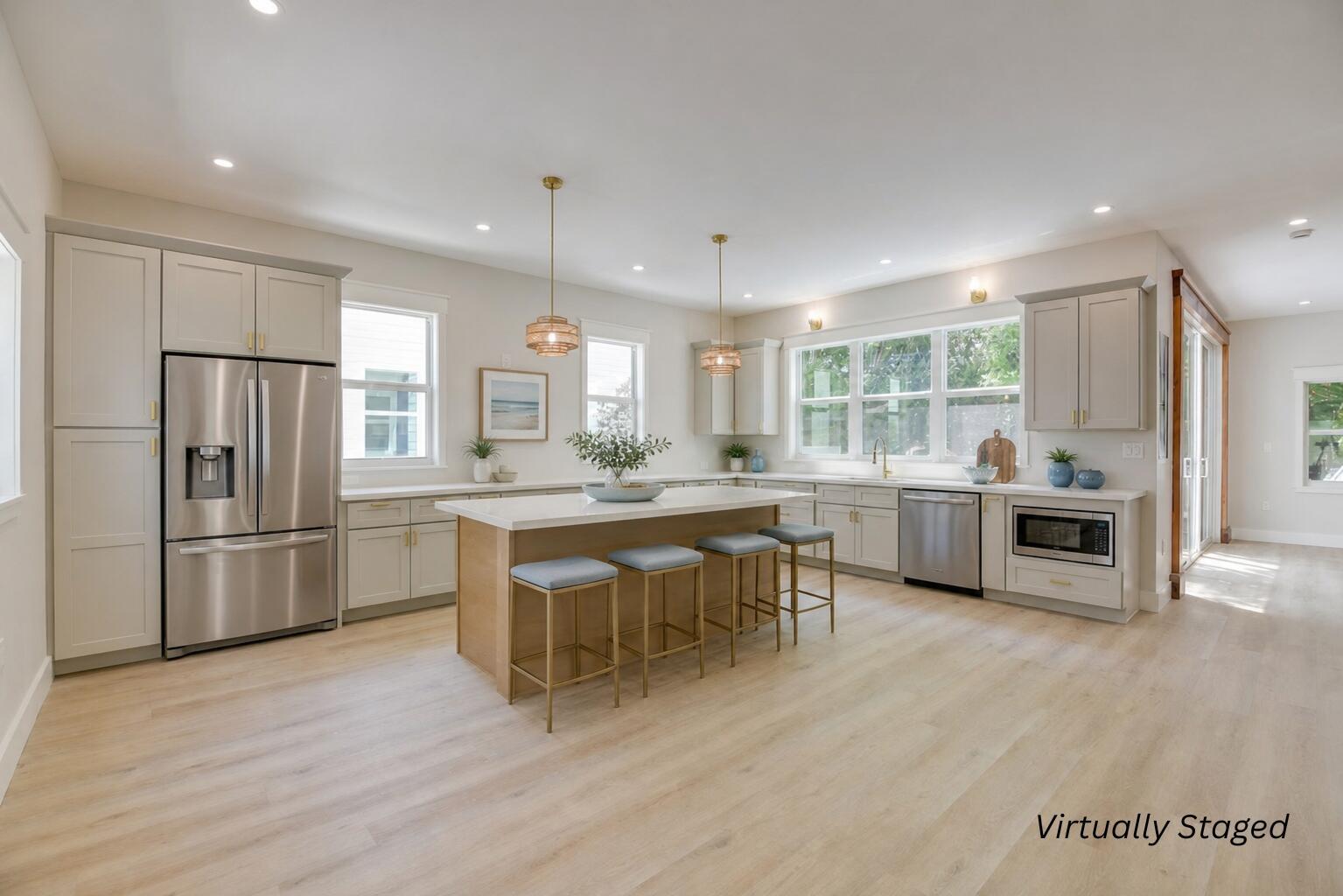 A kitchen with light-colored cabinets, a central island with bar seating, and stainless steel appliances — 1316 Royal Street # 6, Key West FL 33040, KEY WEST, FL