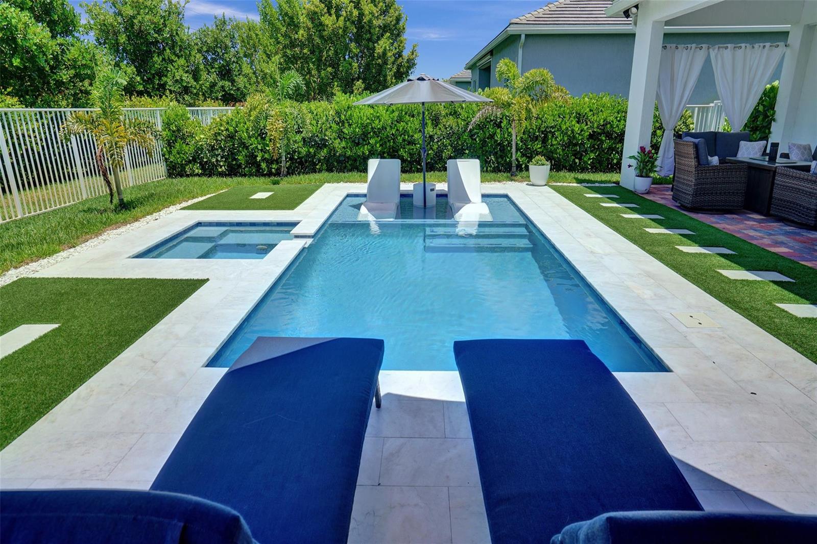 A backyard features a rectangular swimming pool with a tanning ledge, umbrella, and lounge chairs — 9621 Mosler Trail, Lake Worth FL 33467, LAKE WORTH, FL