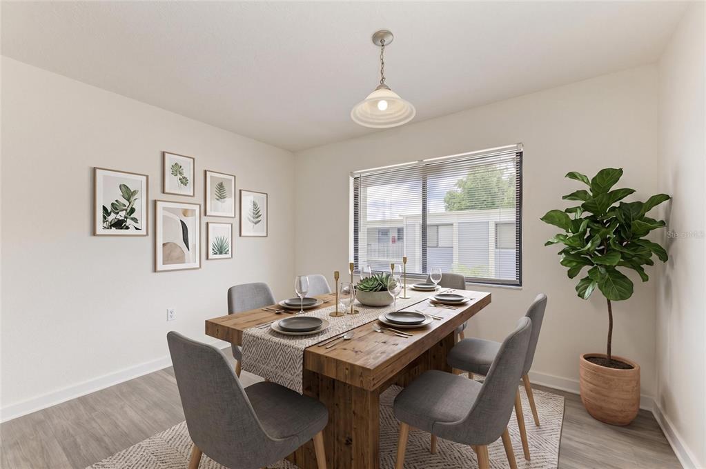 A dining room features a wooden table with six gray chairs and a wall gallery — 5310 26TH STREET W UNIT 1506, BRADENTON, FL
