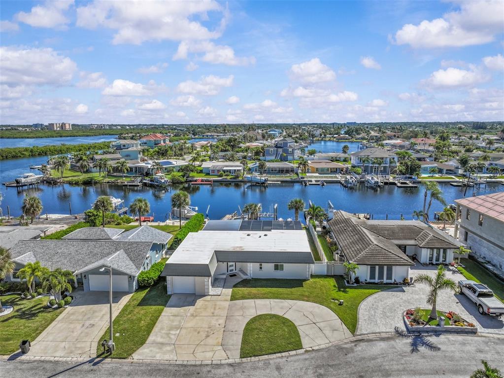 A wooden boat dock features a fish cleaning station and two boat lift mechanisms — 5524 LEEWARD LANE, NEW PORT RICHEY, FL