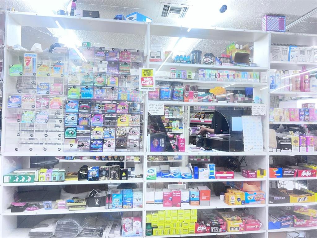 A retail store counter features shelves stocked with lottery tickets, snacks, and various convenience items — 1805 HISTORIC GOLDSBORO BOULEVARD, SANFORD, FL