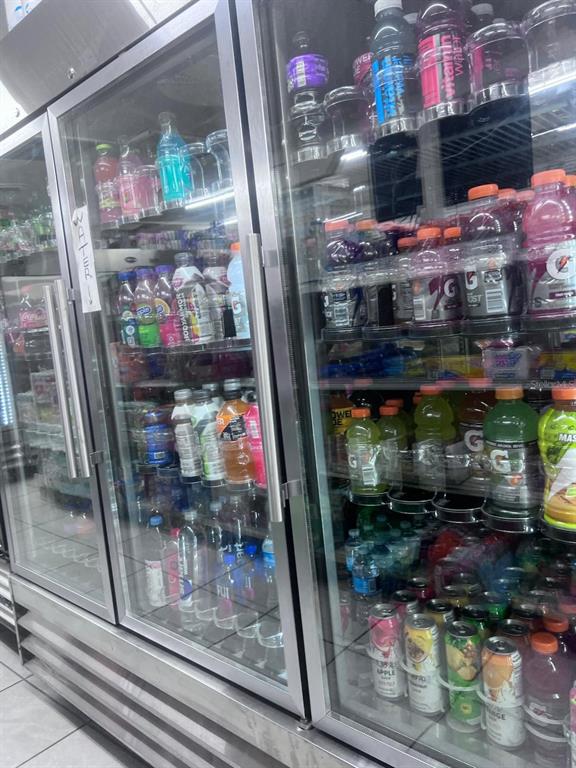 A commercial refrigerator displays various bottled beverages on multiple shelves — 1805 HISTORIC GOLDSBORO BOULEVARD, SANFORD, FL