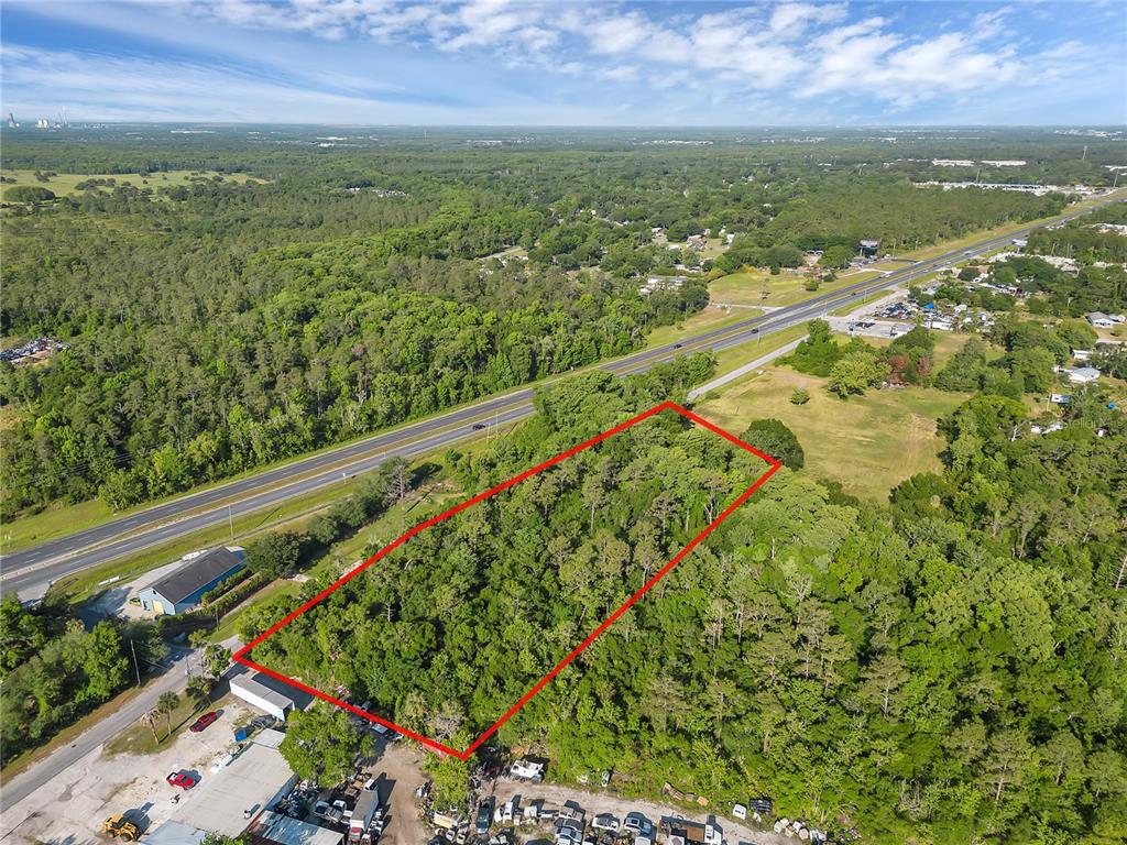 An aerial view shows a rectangular plot of land outlined in red near a highway — 502 N 5TH STREET N, ORLANDO, FL