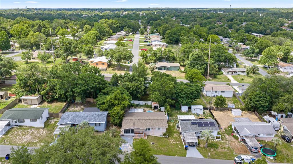 An aerial view shows several single-story houses with yards and trees in a suburban neighborhood — 18 E GOLDEN STREET, BEVERLY HILLS, FL